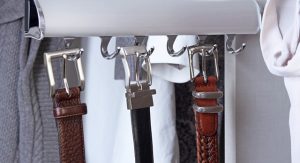 Belts hanging from rack in closet