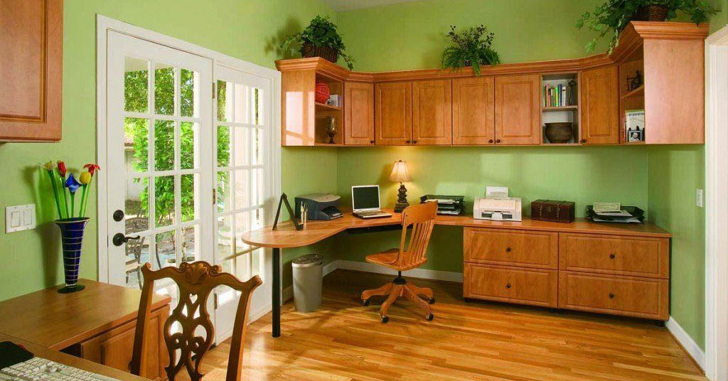 An open space kitchen with wood cabinets and wood flooring