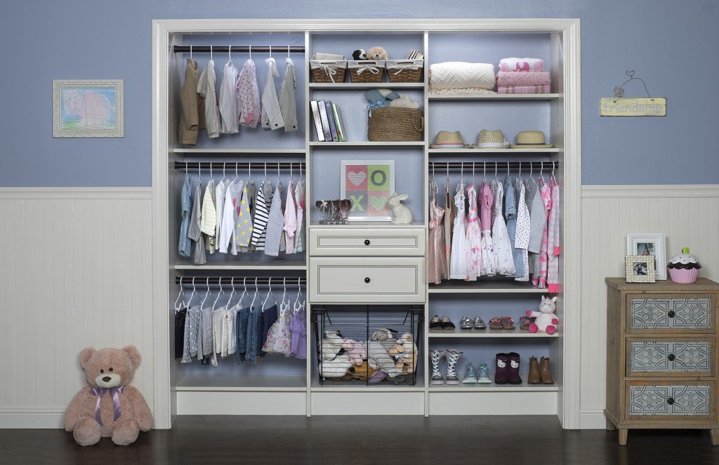 Front view of kids' closet organization system stocked with clothes, shoes, hats, and accessories