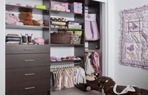 Dark wood kids' closet organizer system in room with toys