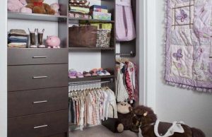 Dark wooden closet organization system in kids' room with toys