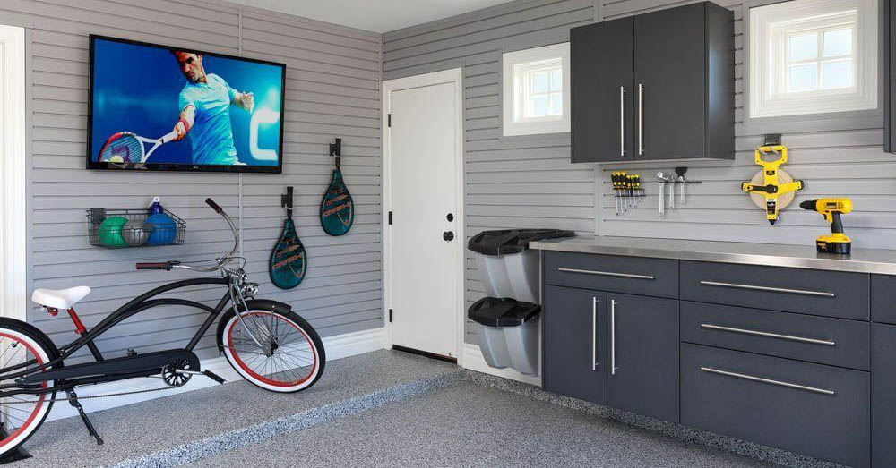 A garage with dark grey cabinets and a bicycle