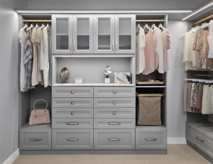 Closet organizer system with white cabinets and shelving