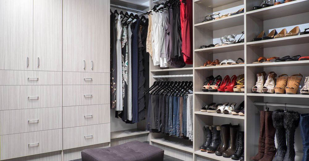 A custom walk-in closet with open shelves and drawers
