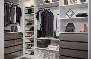 White closet organizer system with brown drawers