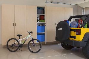 Cabinets in garage with bicycle and vehicle