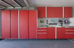 Bright red garage workstation with custom cabinets, drawers, and workbench with wall storage