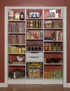 Reach-in closet organizer system filled with food and cooking appliances