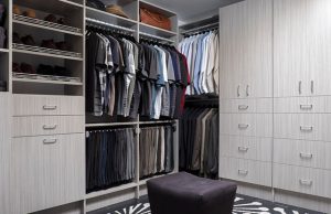 Gray walk-in closet system with men's clothing