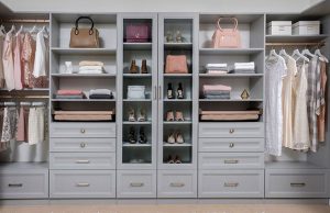Gray closet organizer system with women's clothes, shoes, and bags