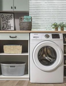 Laundry room shelves, drawers, and cabinets next to washing machine