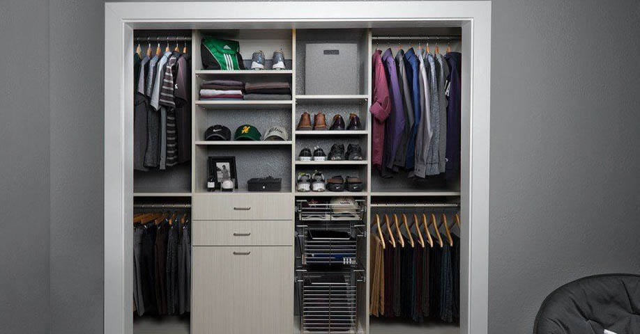 A custom closet with cabinets and open shelves