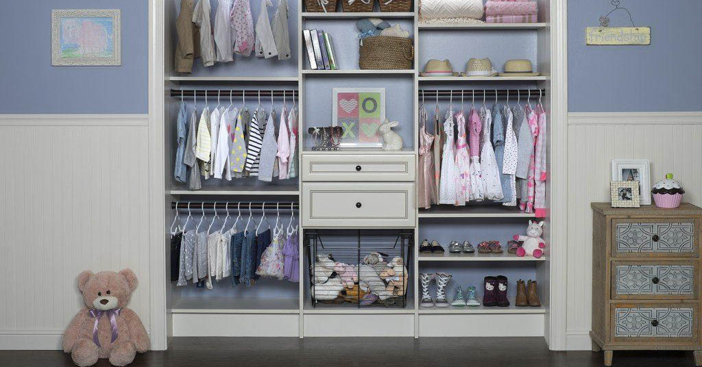 A kid's closet with a teddy bear, a night stand, and open shelves
