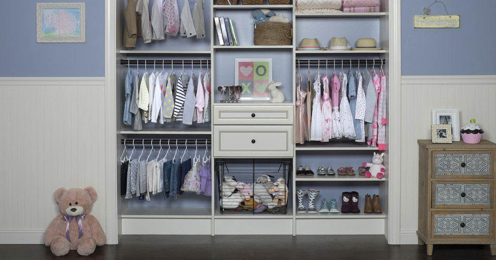 A kid's closet with a teddy bear, a night stand, and open shelves