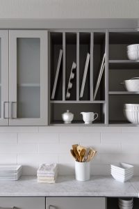 Gray kitchen shelving in white room