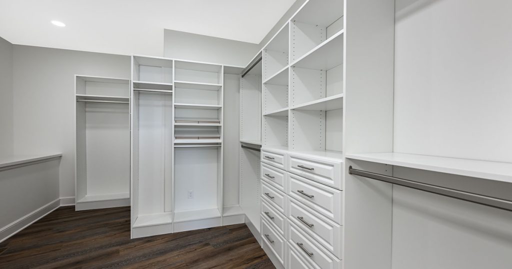 Large custom closet with white cabinets