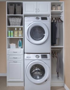 Laundry room organizer system wrapped around washer/dryer stack