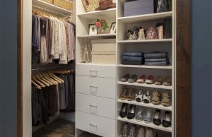 White walk-in closet organizer system inside blue room