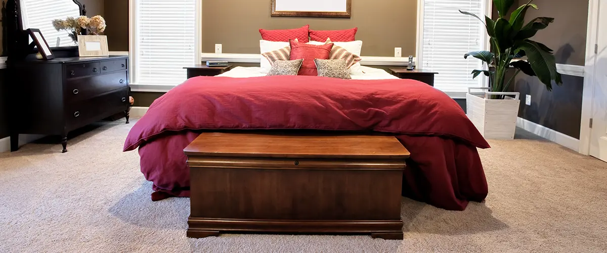 trunk placed at the foot of the bed in a small bedroom