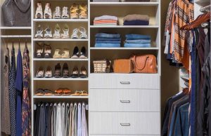 White closet organization system with women's clothing in yellow room