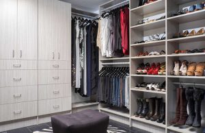 Gray walk-in closet system with men's clothing