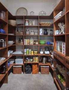 Fully stocked kitchen pantry with natural wood organization system in place