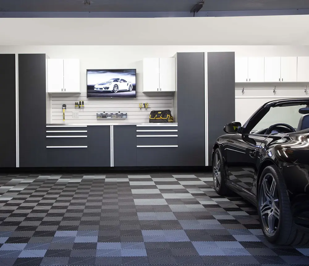 garage interior with car and newly installed cabinets in center