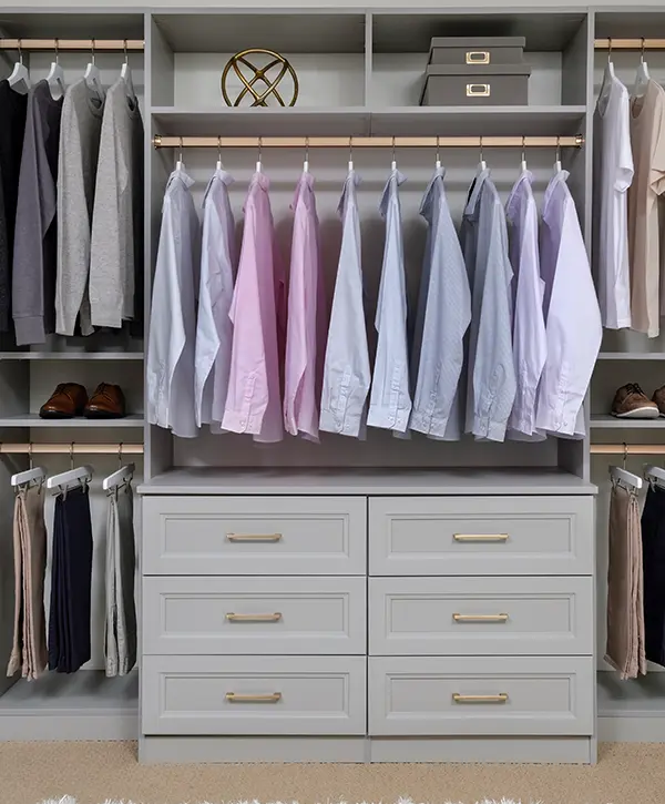 A reach in closet painted off-white for men's clothes
