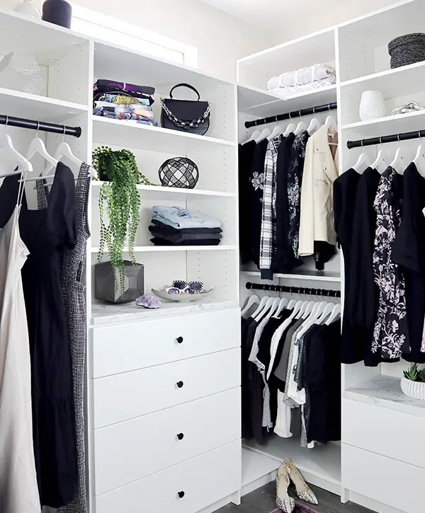 Custom closet painted white but with plenty of black clothes