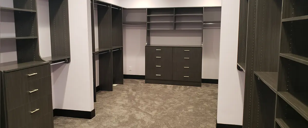 Large walk-in closet with empty shelves