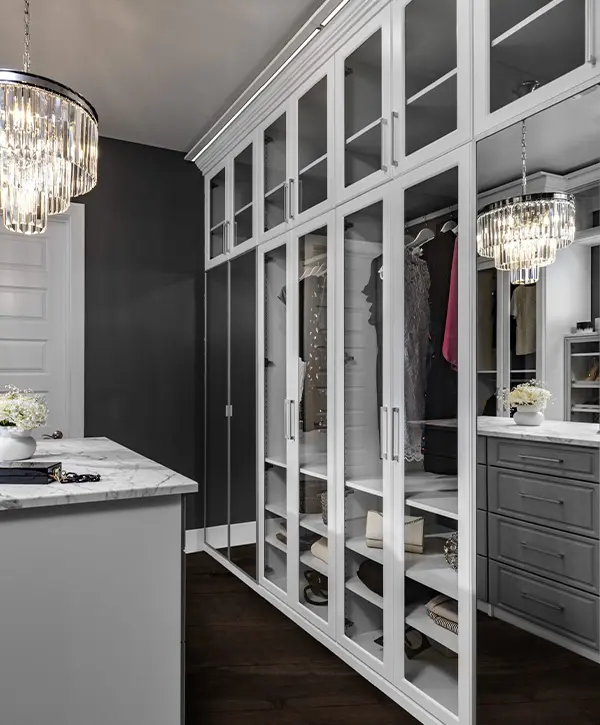 Black doors and drawers on a walk in closet in a home