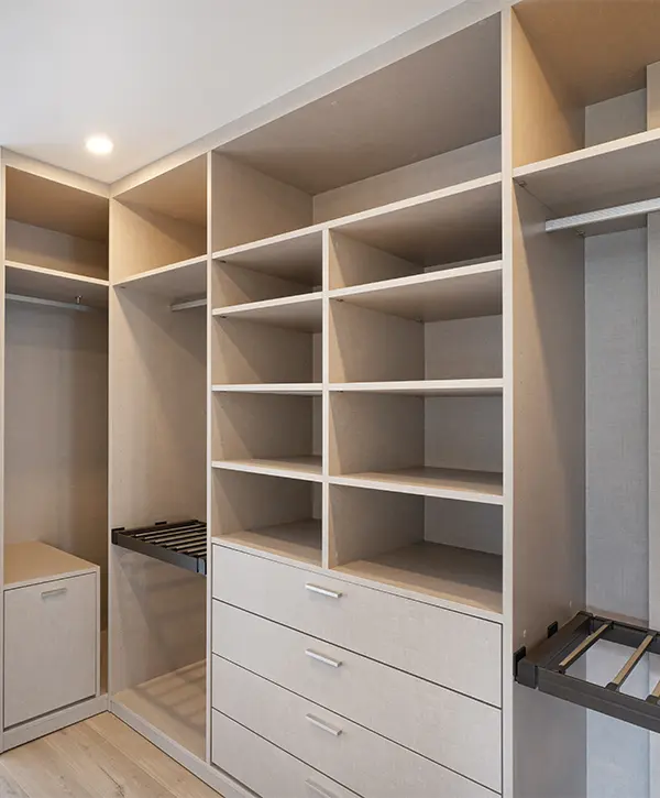 Walk-in closet with open shelves and a few drawers