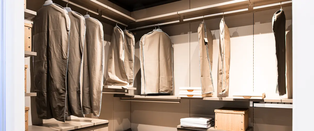 Interior of a walk in closet with hanging clothes