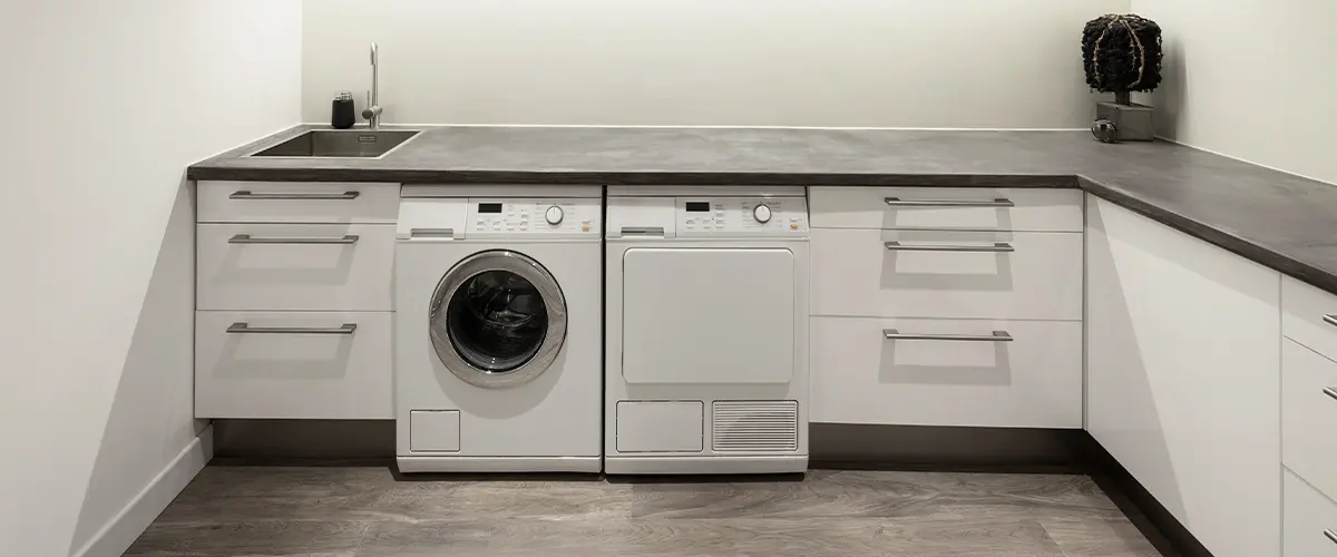 Laundry room white cabinets.