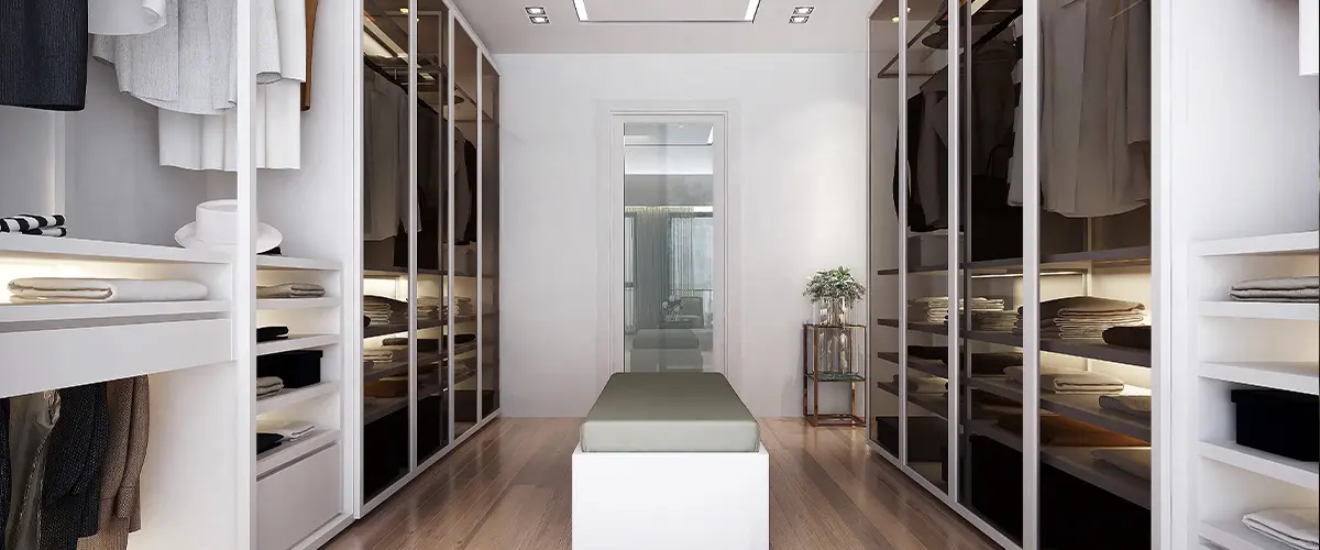 Modern style walk in closet room with white island.