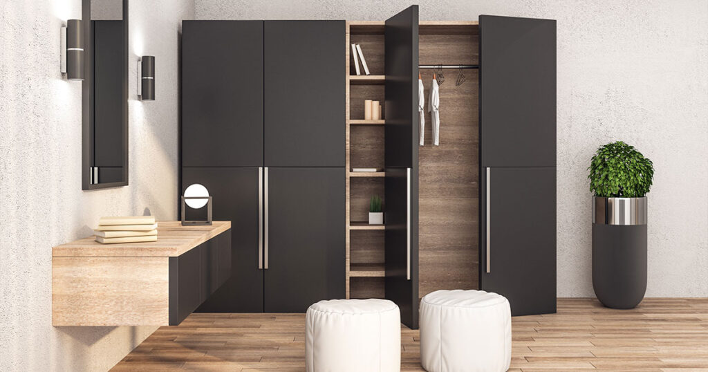 Modern dressing room with black wardrobe closet, white ottomans, and mirror