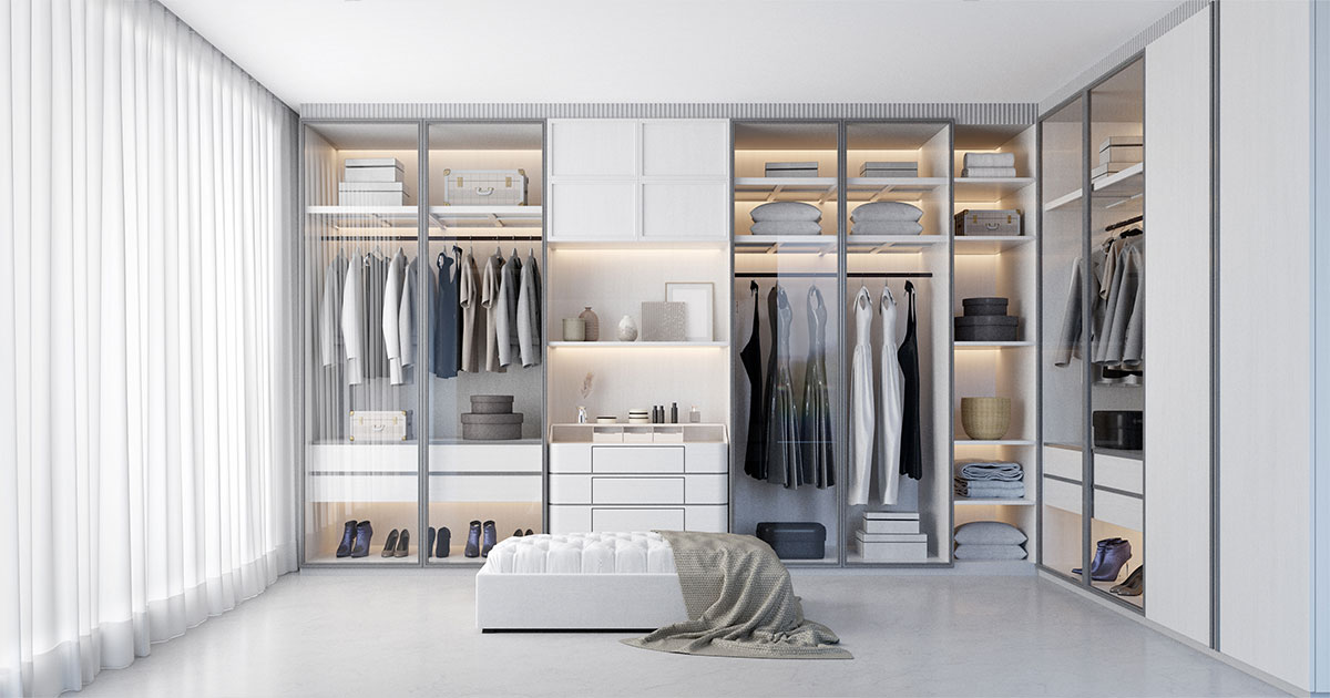 White luxury walk in closet interior with light frome the window.