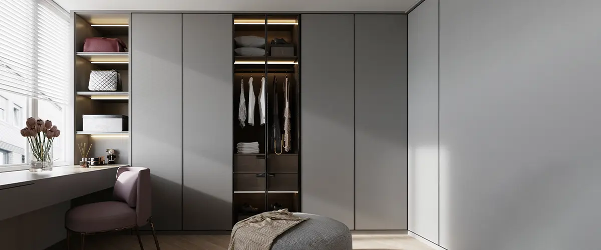Wardrobe closets in tones of gray with sliding doors.