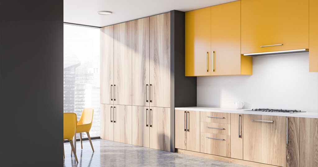 Kitchen with light wood cabinets and stainless steel hardware